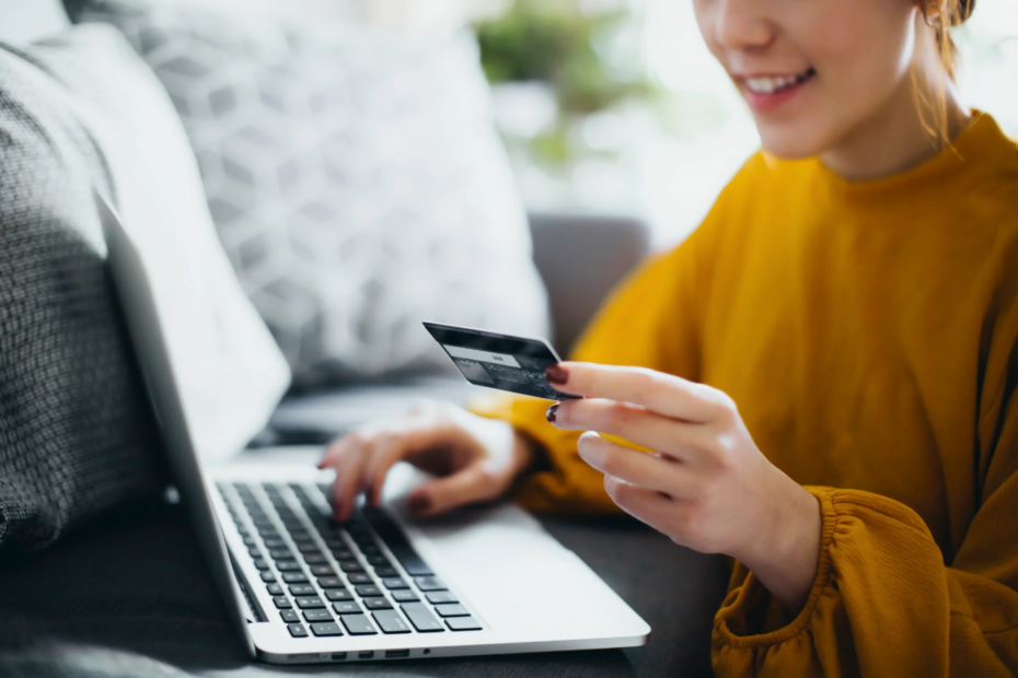 Woman Holding Credit Card With laptop